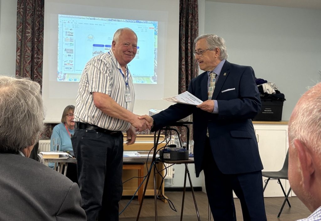 Award-winning author, and Society Chairman, John Goodge receiving his Local History Book Award from Chris Jakes. Source: The Littleport Society.